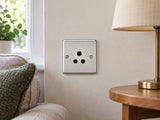 Knightsbridge CL5ABC brushed chrome lighting socket installed in a dry UK living-room wall near an unconnected reading lamp.