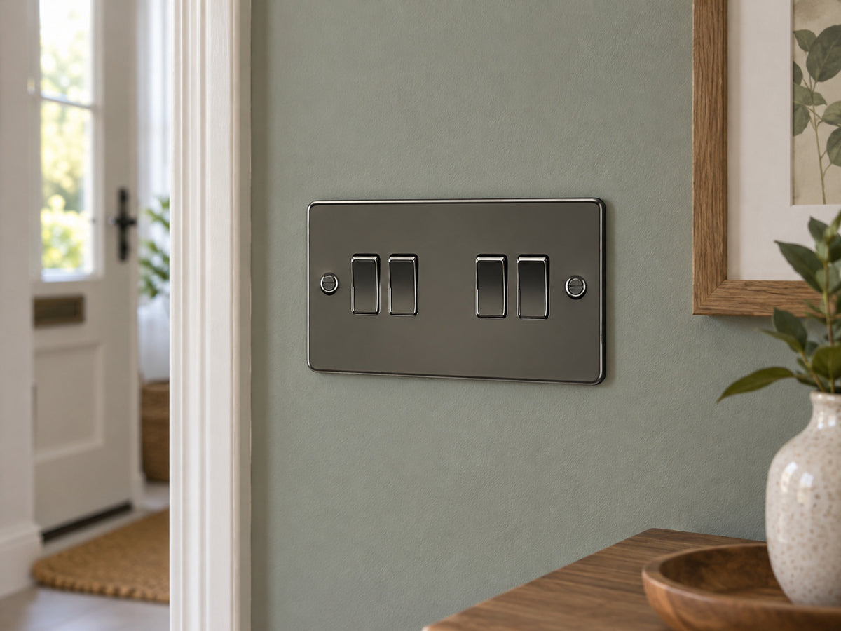 Knightsbridge FP4100GM gunmetal light switch mounted on the wall in a UK living-room entrance wall with muted sage paint.