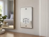 Knightsbridge FP8900PCW polished chrome shaver socket installed in a dry guest-room vanity wall beside a mirror, with no bathroom fixtures.