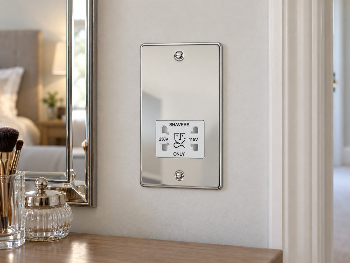 Knightsbridge FP8900PCW polished chrome shaver socket installed in a dry dressing-area wall beside a mirror, with no sink or water nearby.