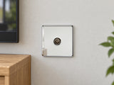 Knightsbridge SF0100PC polished chrome TV outlet fitted on a dry UK living-room wall beside an oak television cabinet.