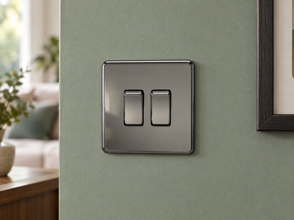 Knightsbridge SF3000BN black nickel light switch fitted on a UK living-room entrance wall with muted sage paint.