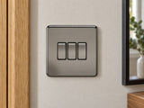 Knightsbridge SF4000BN black nickel light switch fitted on a UK hallway wall beside an oak door frame.