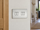 Knightsbridge SF4100PC polished chrome light switch installed on a UK hallway wall beside an oak door frame.